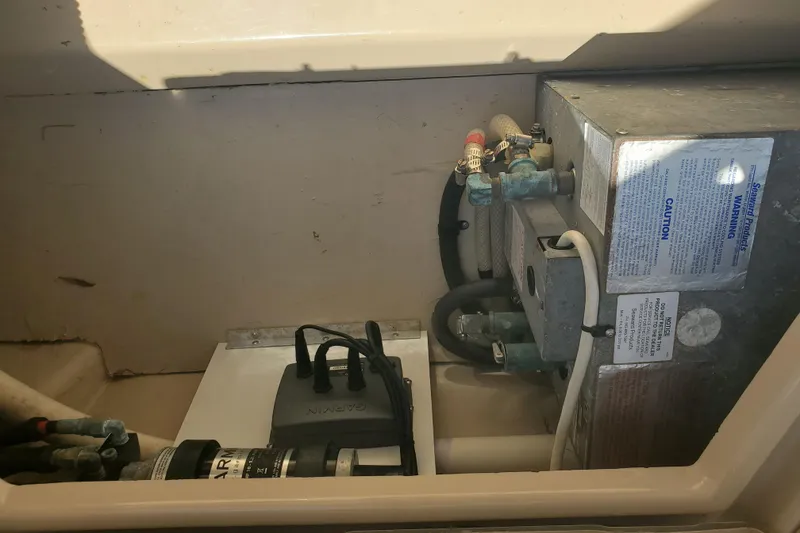 Slide: The Image of Engine compartment of a 2013 Cutwater 26 boat, showing mechanical components and wiring. - 28