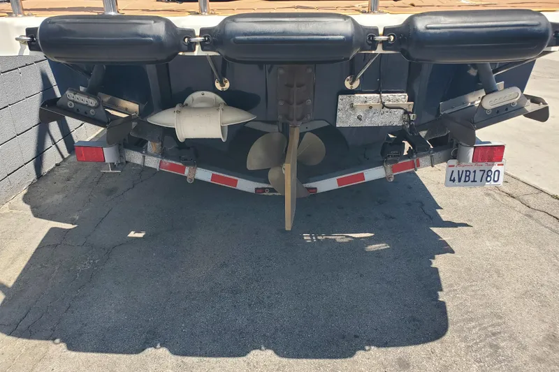 Slide: The Image of Rear view of a 2013 Cutwater 26 boat on a trailer, showing propeller and rudder. - 30