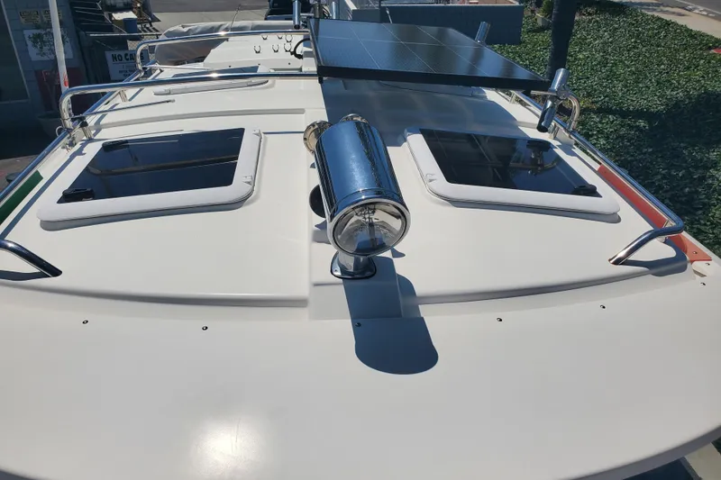 Slide: The Image of 2013 Cutwater 26 boat deck with solar panel and hatches in sunlight. - 36
