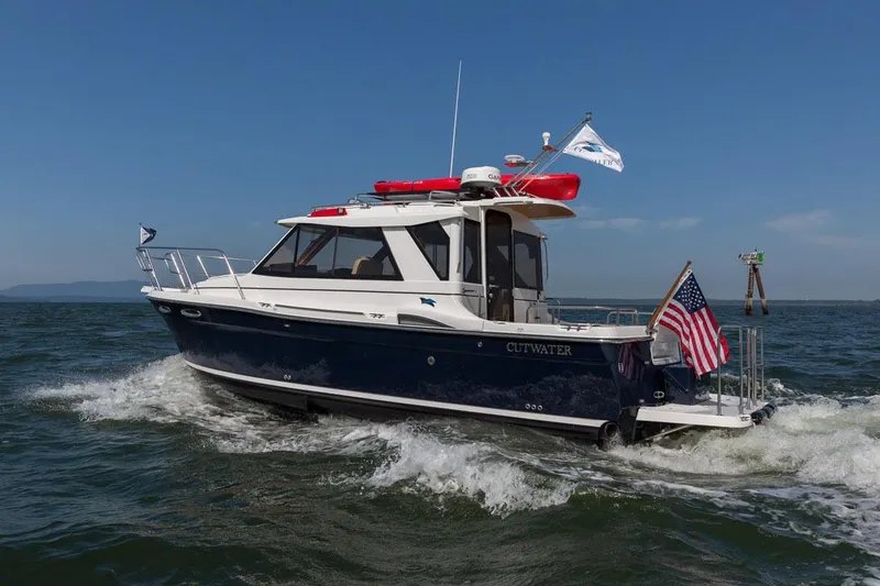 Slide: The Image of Manufacturer Provided Image: 2016 Cutwater 26 boat cruising on open water with American flag. - 37