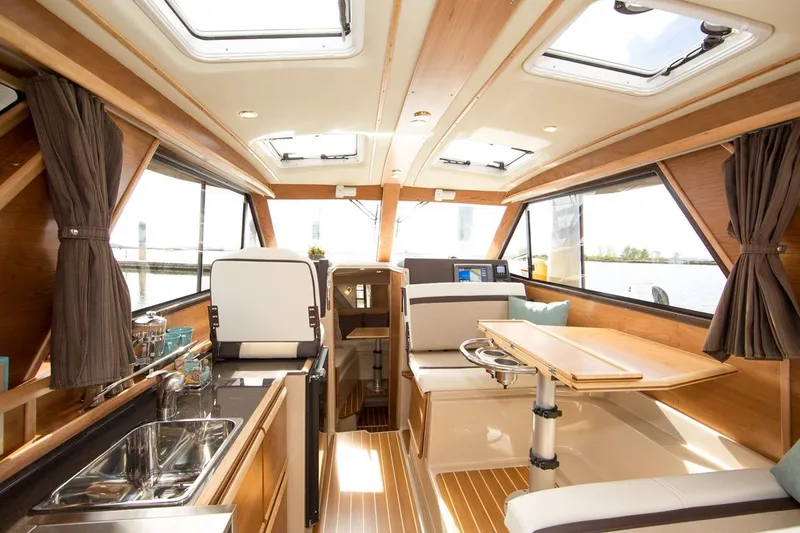 Slide: The Image of Manufacturer Provided Image: Interior of a 2016 Cutwater 26 boat with modern amenities and wooden finishes. - 40