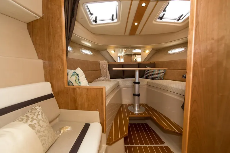 Slide: The Image of Manufacturer Provided Image: Interior of 2016 Cutwater 26 boat with cozy seating and wooden accents. - 45