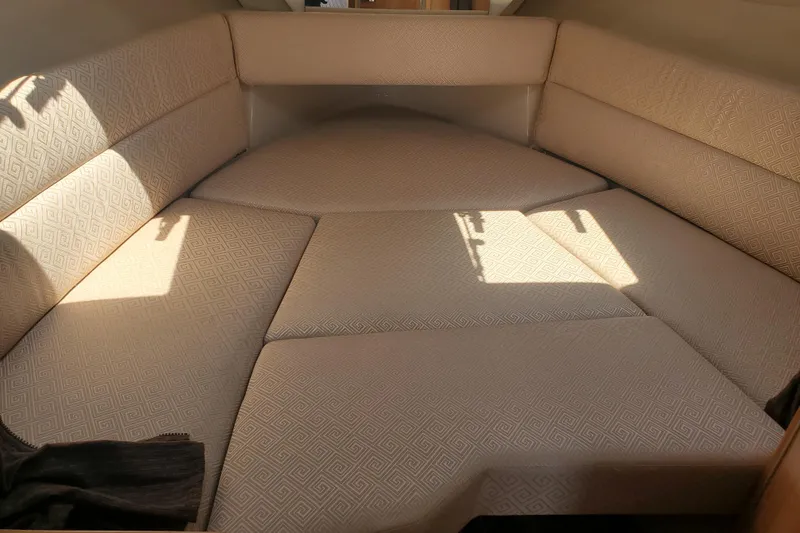 Slide: The Image of Interior cabin of a 2013 Cutwater 26 boat with beige cushioned seating. - 7