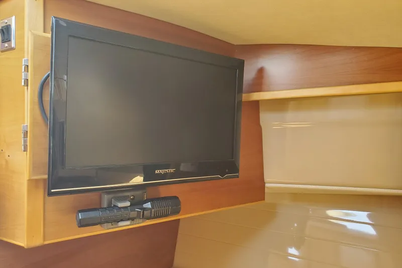 Slide: The Image of Flat-screen TV mounted in a 2013 Cutwater 26 boat interior. - 9