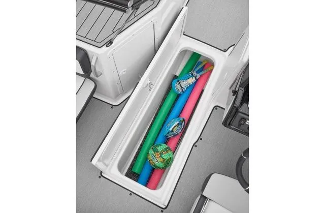 Slide: The Image of 2022 Yamaha AR195 boat storage compartment with pool noodles. - 8