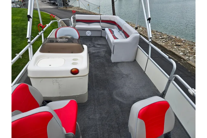 Slide: The Image of 2008 Sun Tracker Fishin' Barge 21 Signature Series pontoon boat interior with seating and console. - 11