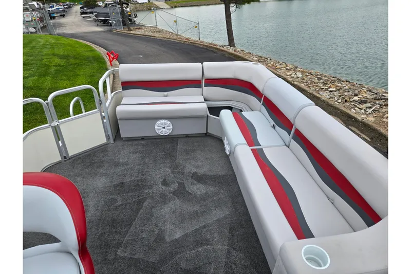 Slide: The Image of 2008 Sun Tracker Fishin' Barge 21 Signature Series with spacious seating by the water. - 14