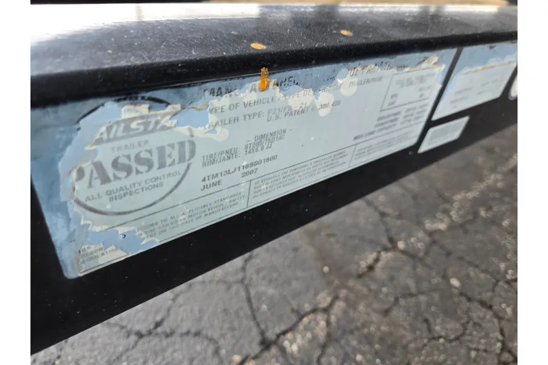 Slide: The Image of 2008 Sun Tracker Fishin' Barge 21 Signature Series trailer inspection sticker, partially worn. - 26