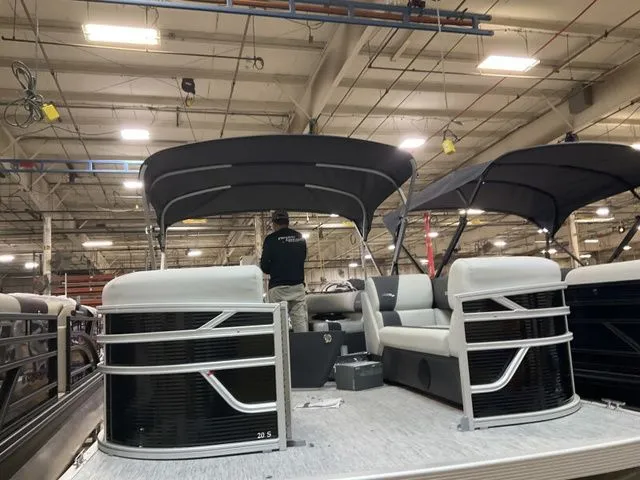 Slide: The Image of 2026 Bennington pontoon boat in factory setting with canopy. - 10