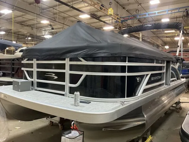 Slide: The Image of Bennington 2026 pontoon boat in warehouse with cover. - 13