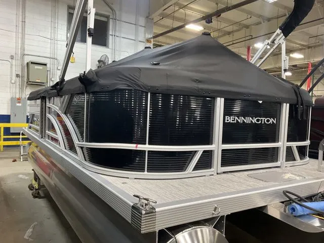 Slide: The Image of Bennington 2026 pontoon boat with black cover in warehouse. - 14