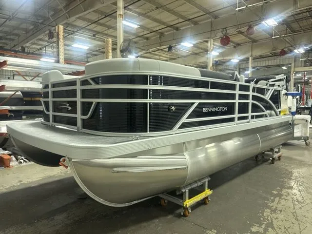 Slide: The Image of 2026 Bennington pontoon boat in a warehouse setting. - 16