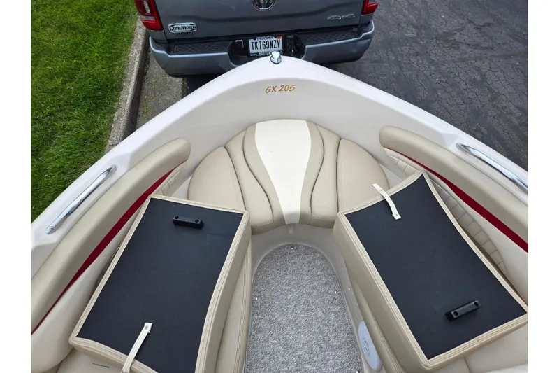 Slide: The Image of 2005 Glastron GX 205 boat interior with beige seating and storage compartments. - 16