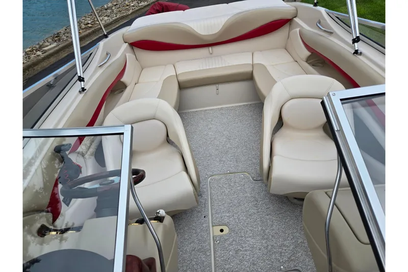 Slide: The Image of 2005 Glastron GX 205 boat interior with beige seating and red accents. - 19