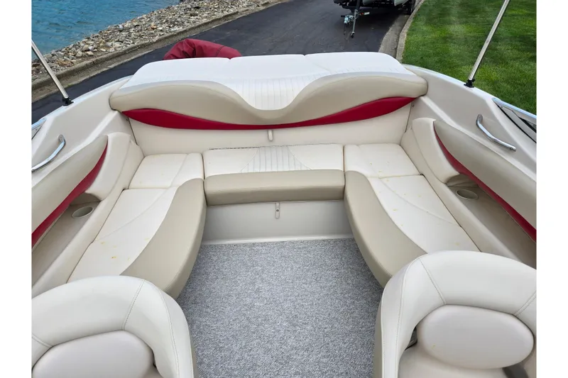 Slide: The Image of Luxurious seating area of a 2005 Glastron GX 205 boat with beige and red upholstery. - 20