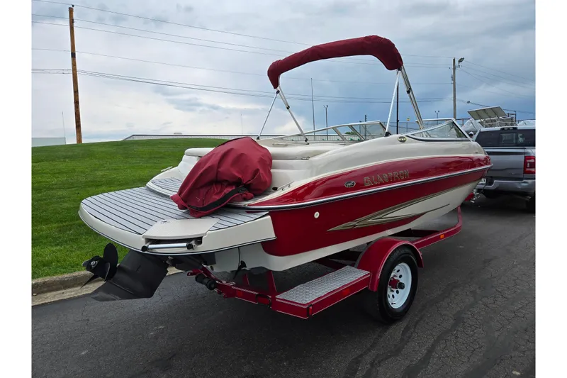 Slide: The Image of 2005 Glastron GX 205 boat with red and white design on a trailer. - 3