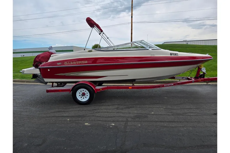 Slide: The Image of 2005 Glastron GX 205 boat on trailer, red and white design, parked outdoors. - 4