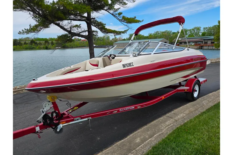 Slide: The Image of 2005 Glastron GX 205 boat on trailer by a scenic lakeside. - 8