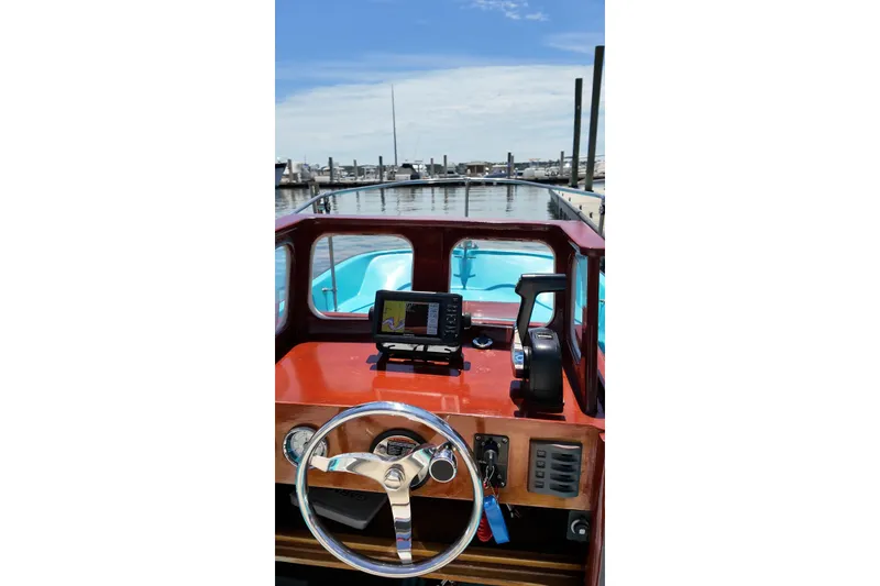 Slide: The Image of Interior view of a 1969 Boston Whaler 17 Montauk boat at a marina. - 3