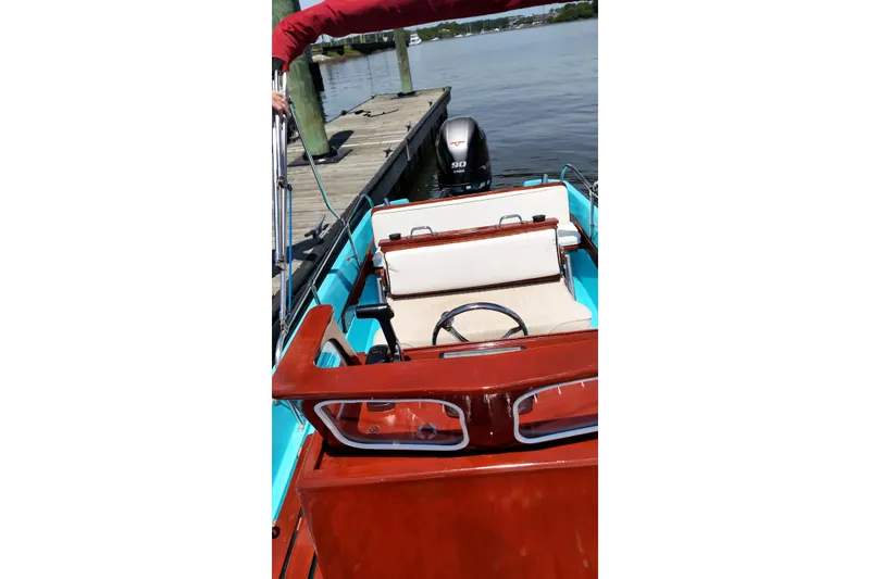 Slide: The Image of 1969 Boston Whaler 17 Montauk boat with classic wooden details and modern outboard motor. - 4