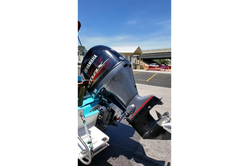 Slide: The Image of 1969 Boston Whaler 17 Montauk with Yamaha outboard motor in a sunny parking lot. - 5