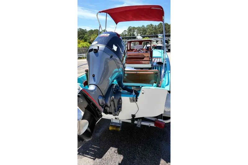 Slide: The Image of 1969 Boston Whaler 17 Montauk boat with outboard motor and red canopy. - 6