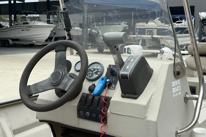 Slide: The Image of 2008 SeaArk 1652 MV boat dashboard with steering wheel and controls. - 11