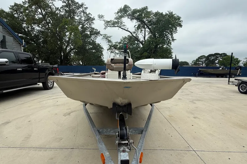 Slide: The Image of 2008 SeaArk 1652 MV boat on trailer, parked outdoors with trees in background. - 7