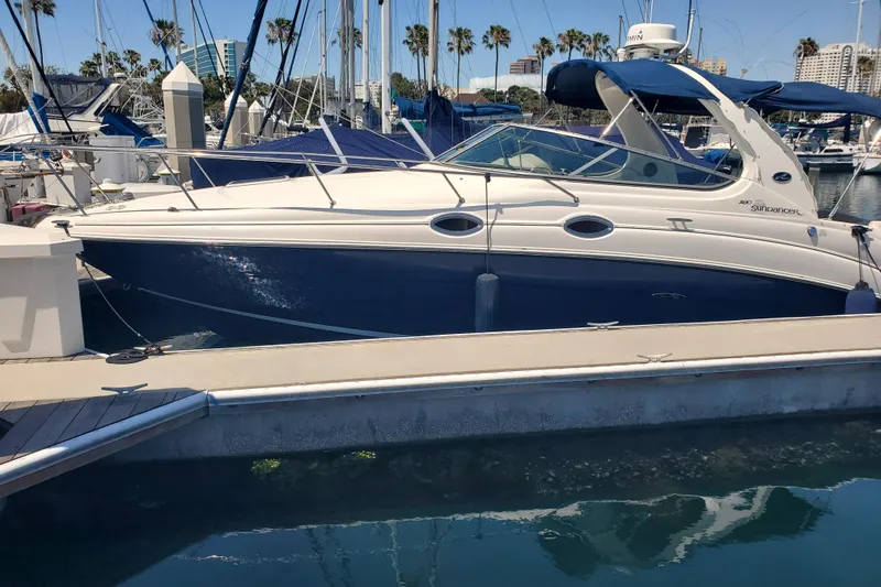 Slide: The Image of 2008 Sea Ray Sundancer 280 docked at marina with palm trees in background. - 1