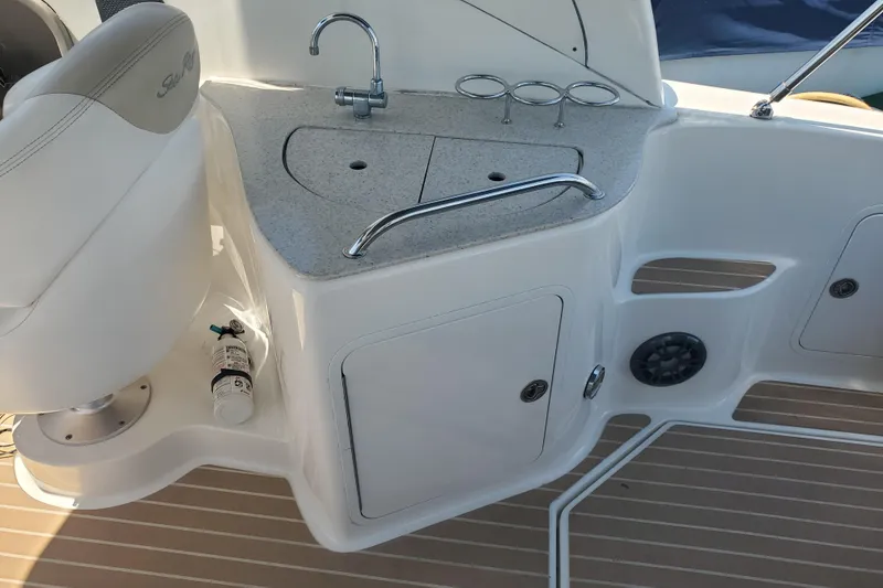 Slide: The Image of Cockpit sink area of 2008 Sea Ray Sundancer 280 with faucet and storage. - 10