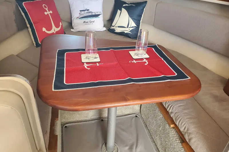 Slide: The Image of Interior of 2008 Sea Ray Sundancer 280 with nautical-themed decor and table setting. - 11