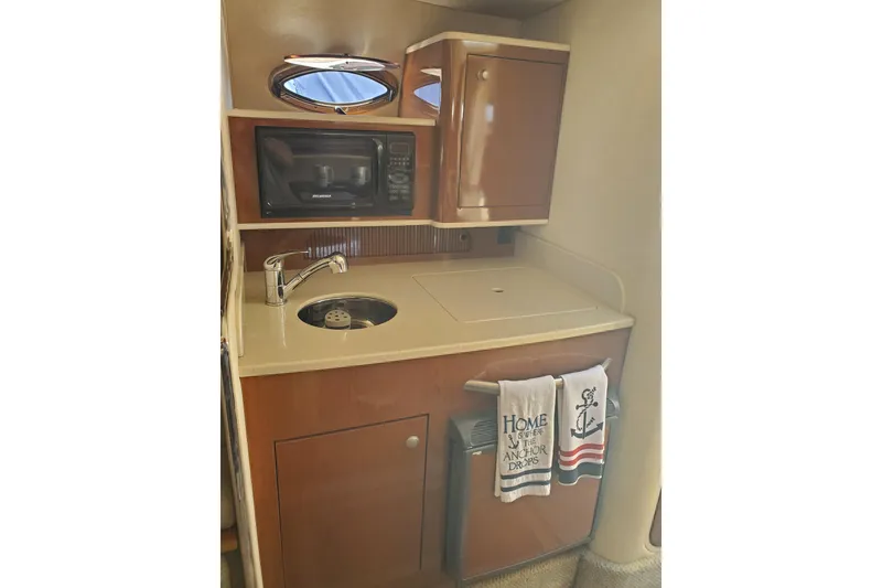 Slide: The Image of 2008 Sea Ray Sundancer 280 galley with sink, microwave, and storage cabinet. - 15