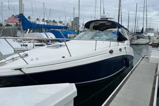 Slide: The Image of 2008 Sea Ray Sundancer 280 docked at marina with sailboats in background. - 2