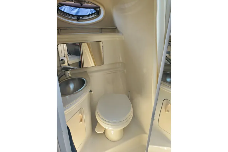 Slide: The Image of 2008 Sea Ray Sundancer 280 bathroom with sink, toilet, and mirror. - 21