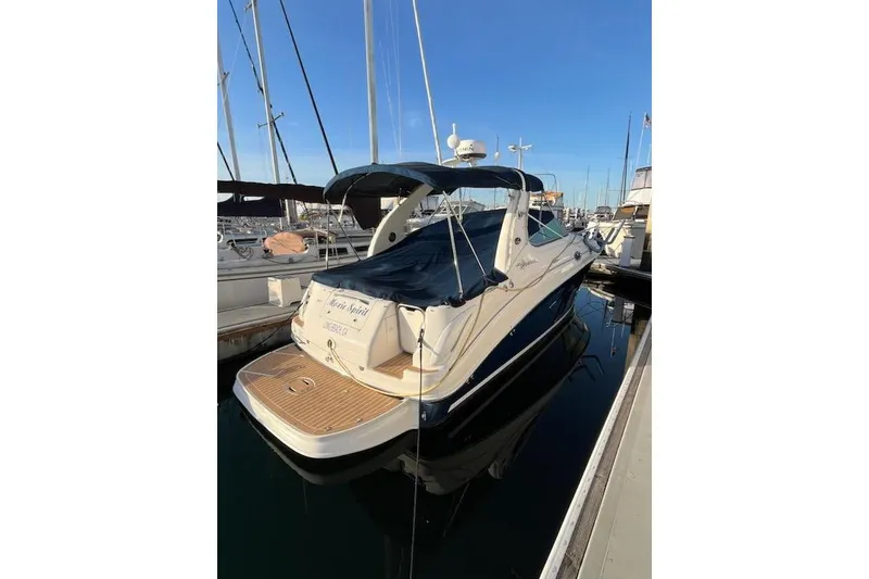 Slide: The Image of 2008 Sea Ray Sundancer 280 docked at marina, featuring sleek design and covered deck. - 4