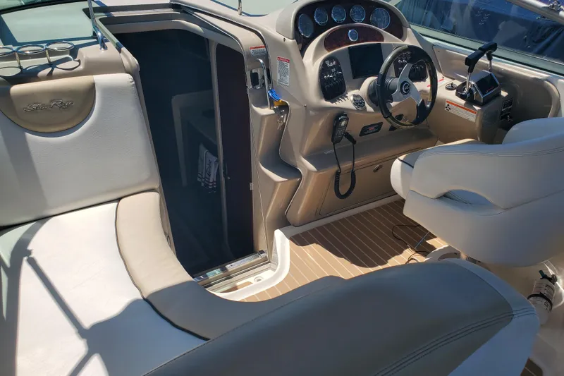 Slide: The Image of 2008 Sea Ray Sundancer 280 cockpit with steering wheel, controls, and seating area. - 5