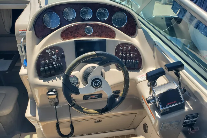 Slide: The Image of Control panel of a 2008 Sea Ray Sundancer 280 boat with steering wheel and gauges. - 7