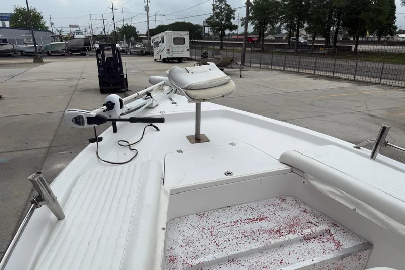 Slide: The Image of 2005 Sea Pro SV2100CC Bay Boat with trolling motor in a marina setting. - 10
