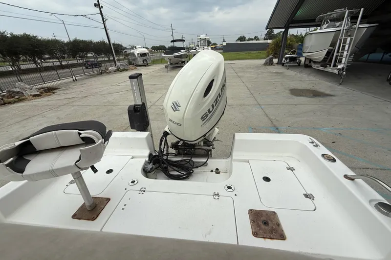 Slide: The Image of 2005 Sea Pro SV2100CC Bay Boat with Suzuki outboard motor in a marina setting. - 12