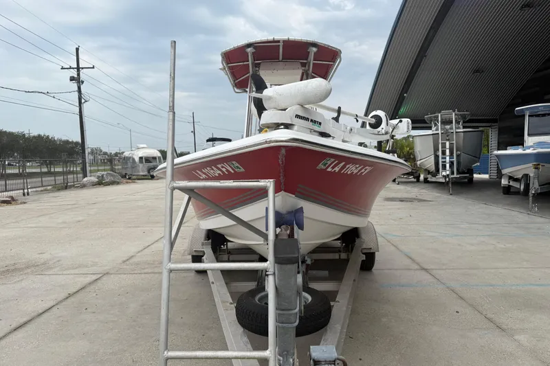 Slide: The Image of 2005 Sea Pro SV2100CC Bay Boat on trailer, parked outdoors near a metal building. - 7