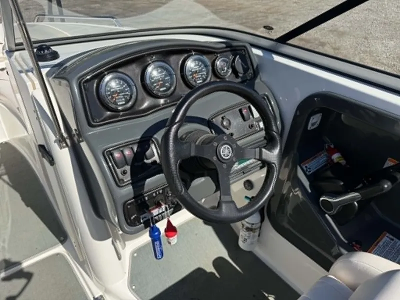 Slide: The Image of 2009 Yamaha SX 230 boat dashboard with steering wheel and gauges. - 5