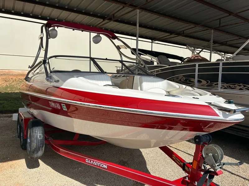 The Image of 2008 Glastron GX 205 boat on trailer under cover. - 1