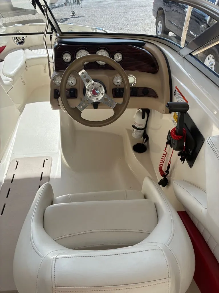 Slide: The Image of Interior of a 2008 Glastron GX 205 boat with steering console. - 10