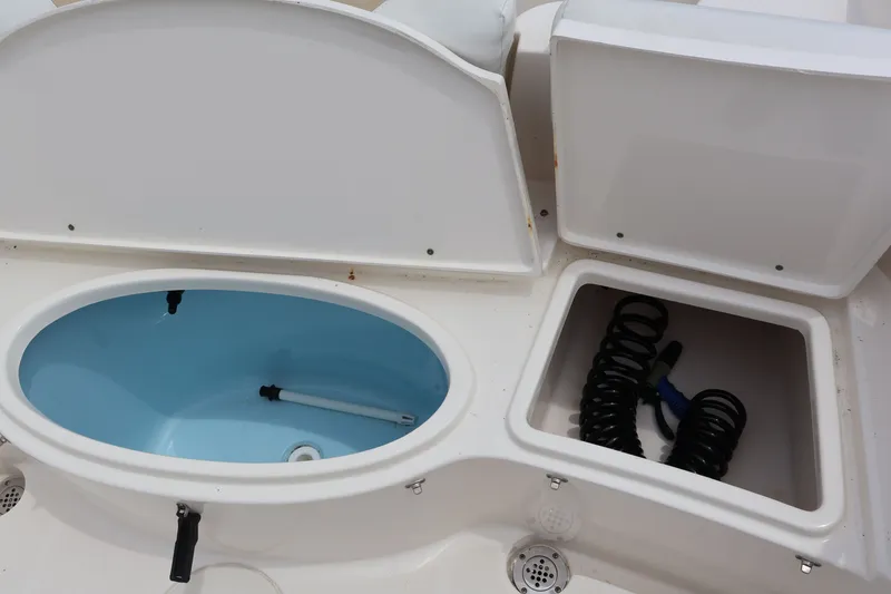 Slide: The Image of 2020 Bulls Bay 230CC boat with storage compartments and blue tub. - 10