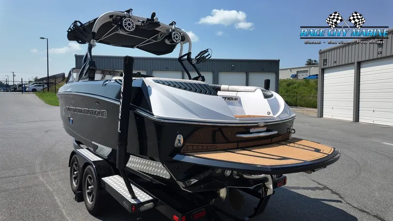 Slide: The Image of A 2015 Nautique G23 on a trailer, featuring a sleek black and white design. - 7
