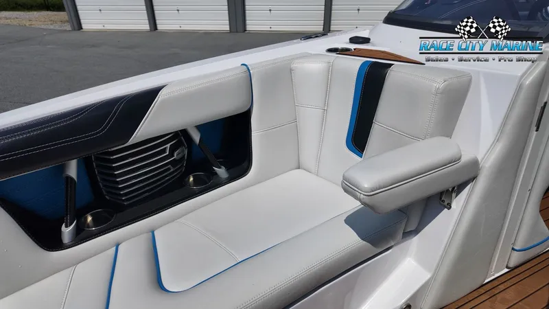 Slide: The Image of The image shows the white interior of a 2015 Nautique G23 with blue accents. - 24