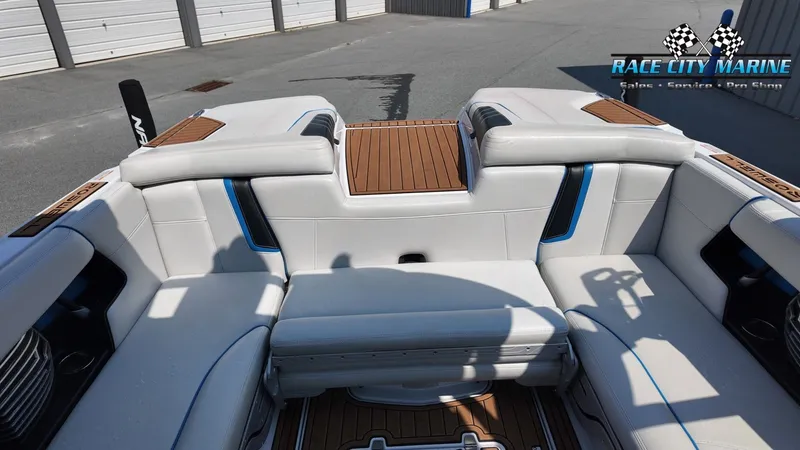 Slide: The Image of The image shows the interior of a 2015 Nautique G23 with white upholstery and wood accents. - 16