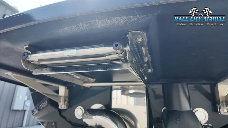 Slide: The Image of Close-up of the stern of a 2015 Nautique G23 showing the trim tab mechanism. - 9