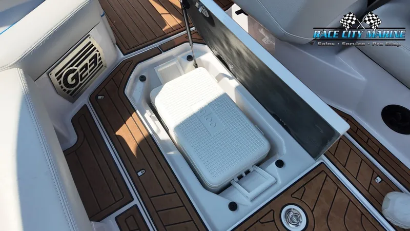 Slide: The Image of A 2015 Nautique G23 featuring a built-in cooler in the boat's floor. - 41