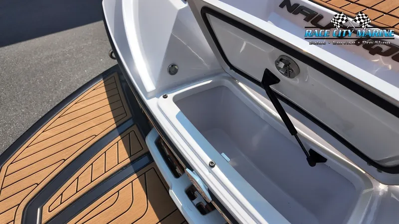 Slide: The Image of The image shows the storage compartment of a 2015 Nautique G23 with wood-pattern flooring. - 14